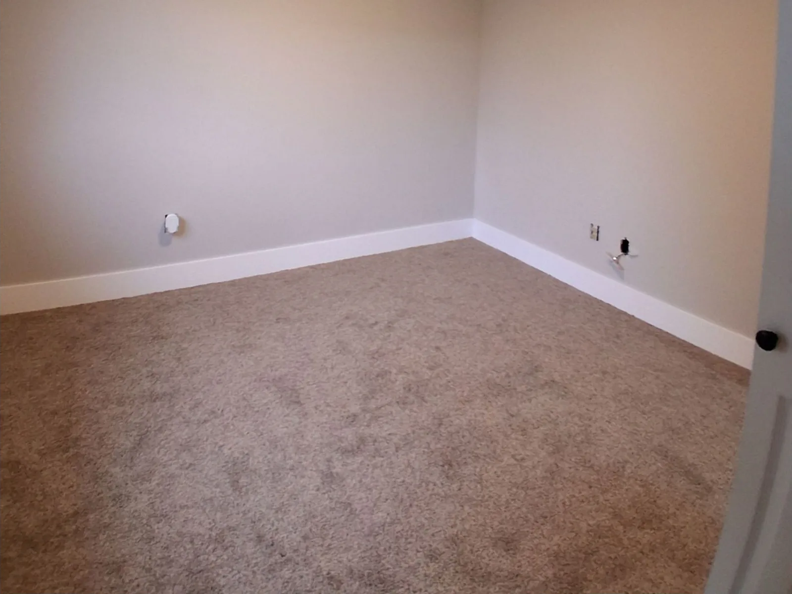 Finished bedroom with new carpet, fresh paint and white baseboard trim