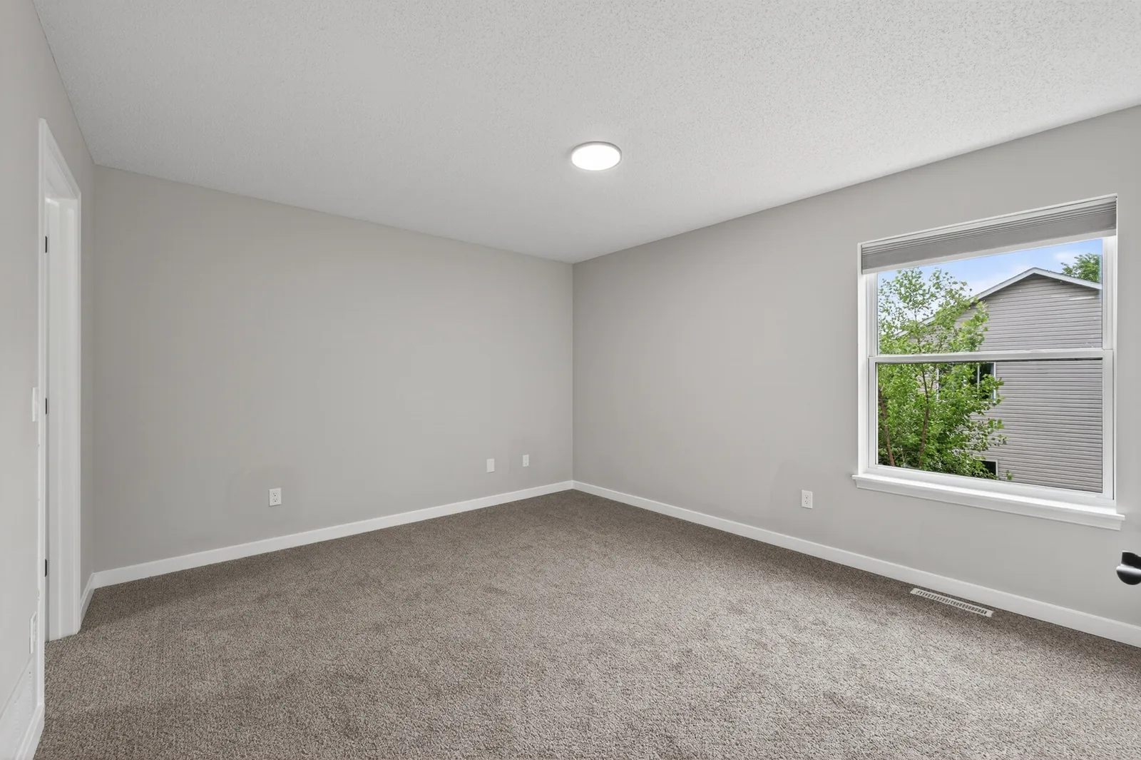 Carpeted bedroom in a completed Due North Equity renovation