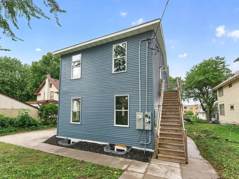 Side of the duplex with the exterior stair to the upper unit