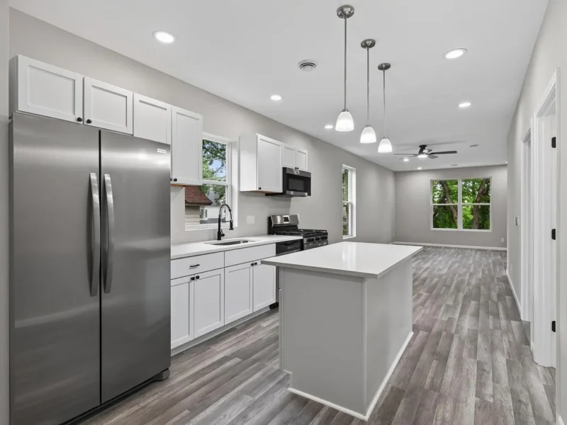 Kitchen with an island, stainless appliances and pendant lights