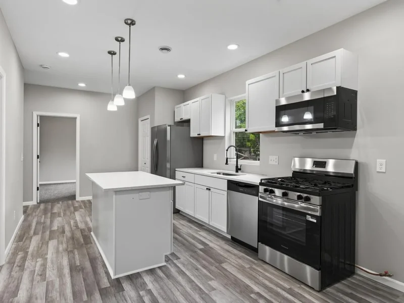 Kitchen with a gas range, dishwasher and island