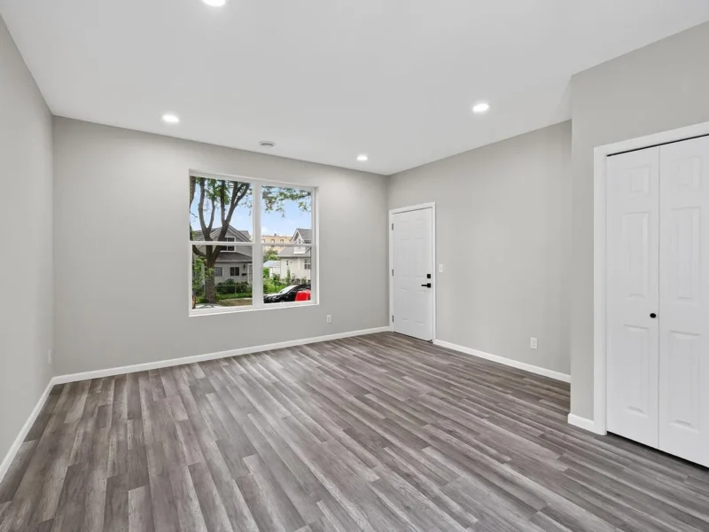 Living room with a window and closet doors