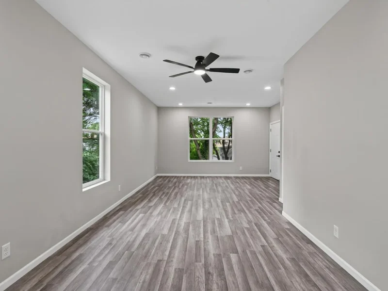 Living room with a ceiling fan and a large window