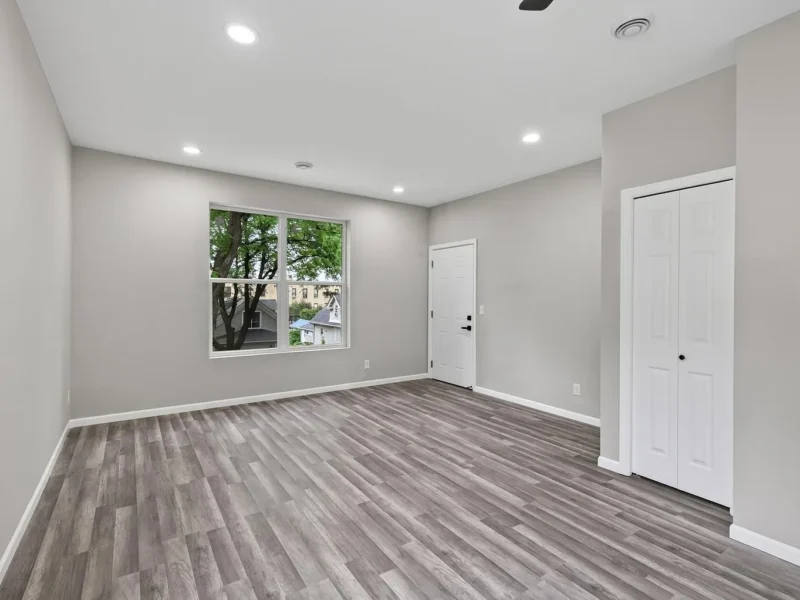Living room with a window and two doors