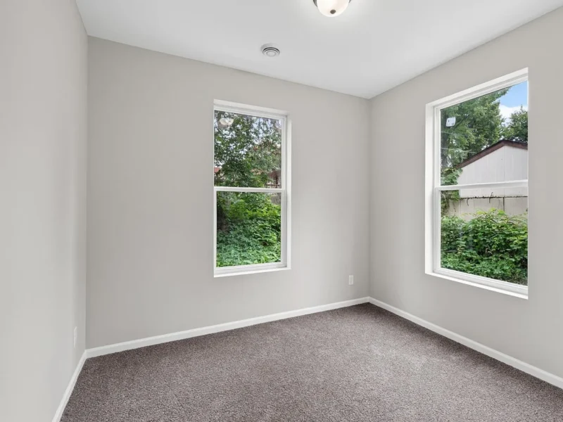 Carpeted bedroom with two windows