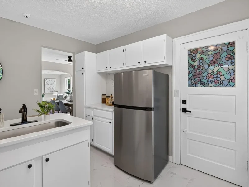 Kitchen with a stainless refrigerator and a doorway to the hall