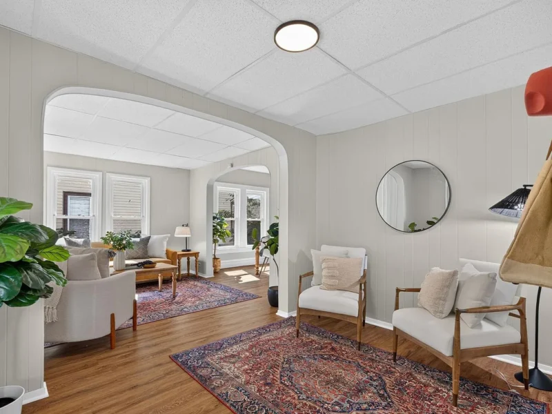 Living room with an arched opening through to the dining room