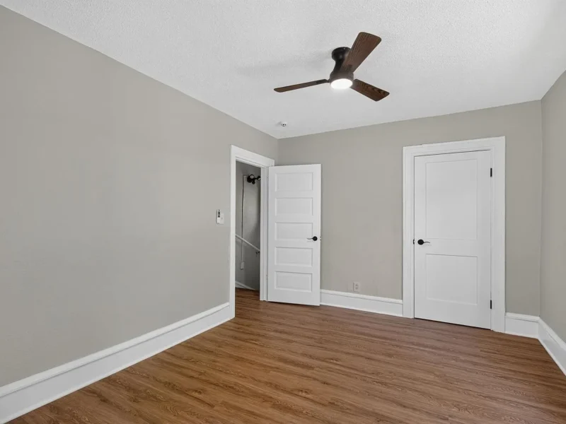 Empty room with hard-surface flooring and two doorways