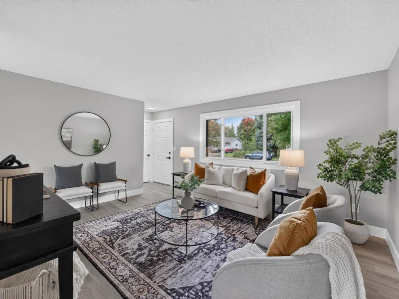 Living room seating area beneath a wide picture window