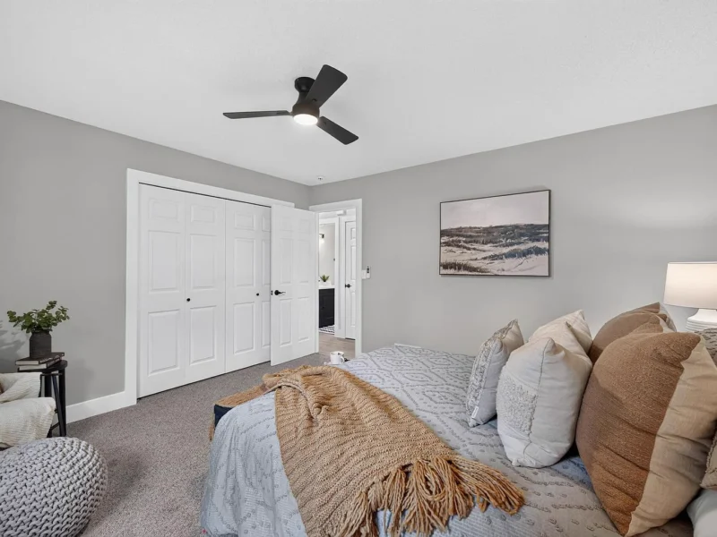 Carpeted bedroom with white double closet doors