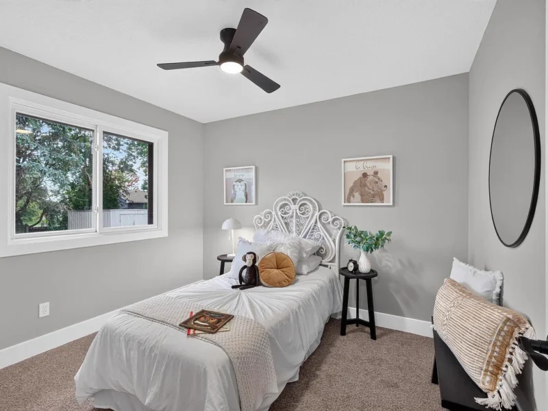 Bedroom with a white bed beneath a window