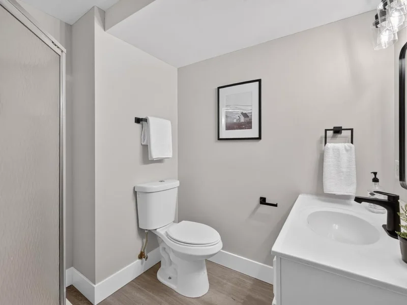Bathroom with a white vanity and a black faucet