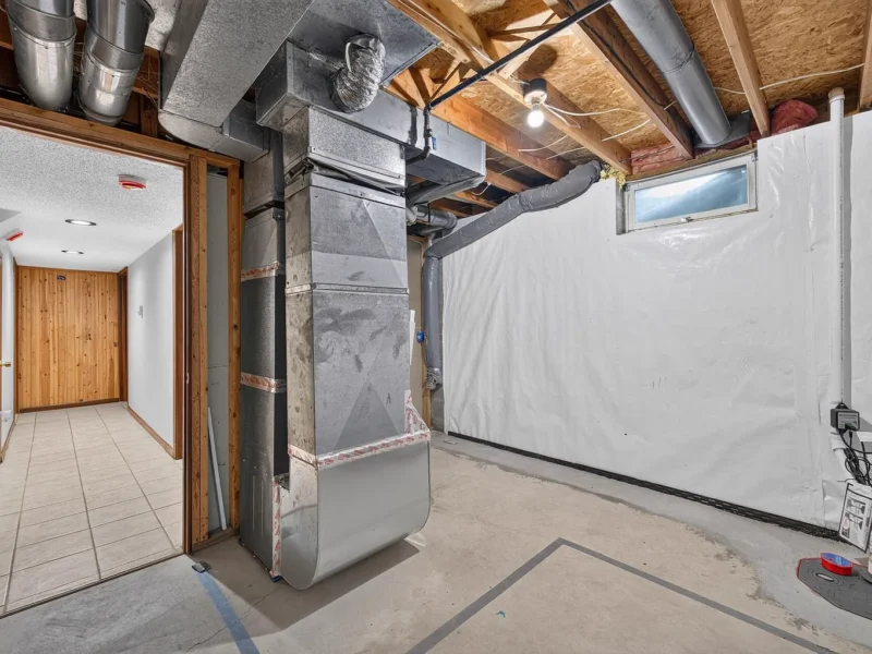 Unfinished utility area with the furnace and ductwork