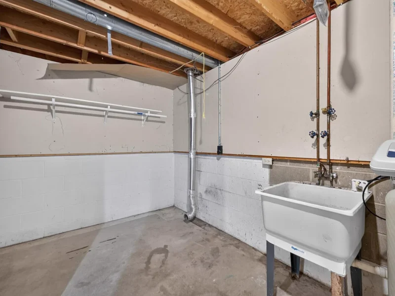 Unfinished laundry area with a utility sink