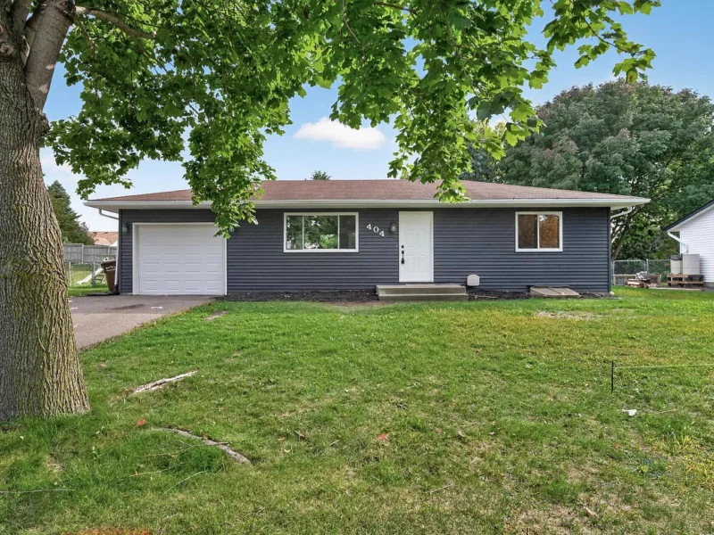 Front of the house behind a large shade tree
