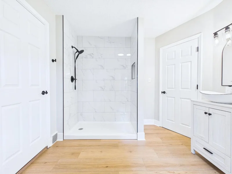Bathroom with a tiled walk-in shower and a built-in linen cabinet