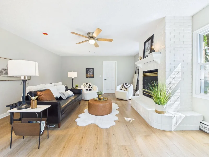 Living room with a white painted brick fireplace