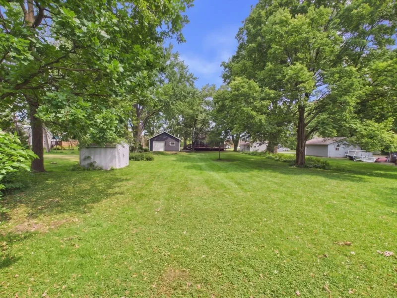 Lawn and mature trees behind the house