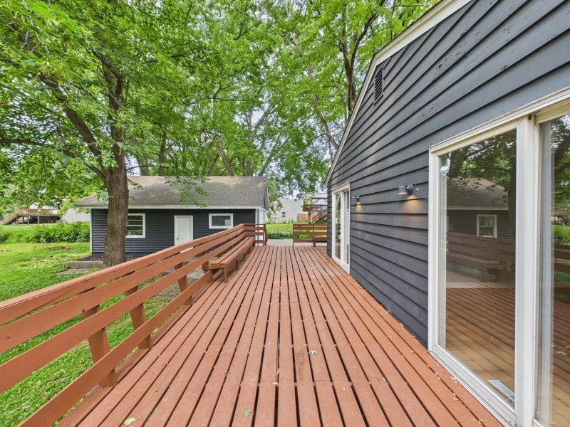 Stained deck running along the back of the house
