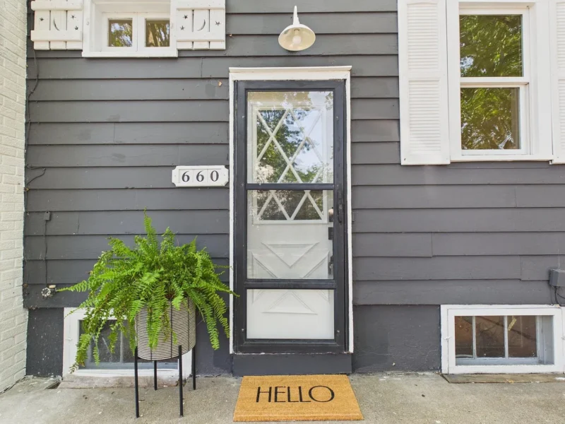 Front door with the house number and a storm door