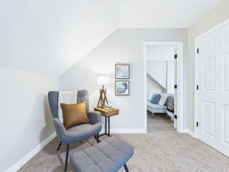 Upstairs sitting area under a sloped ceiling