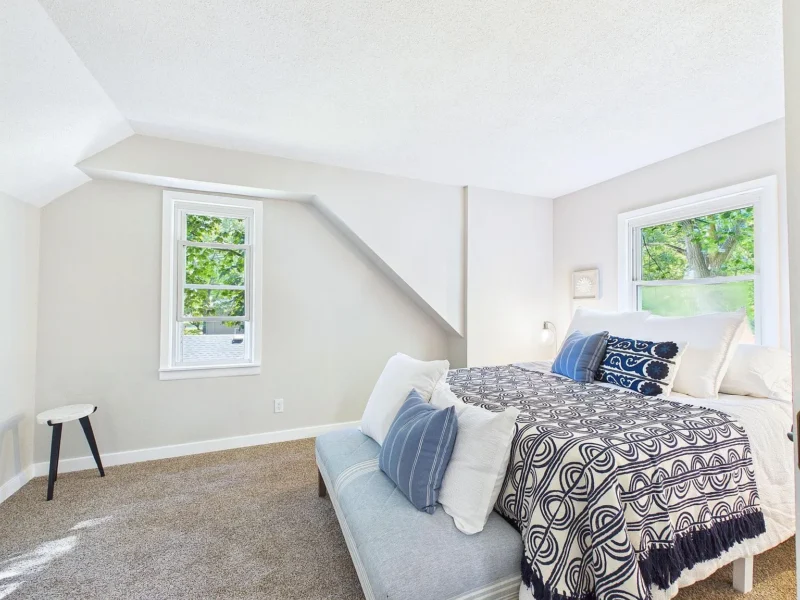 Upstairs bedroom with carpet and a dormer window
