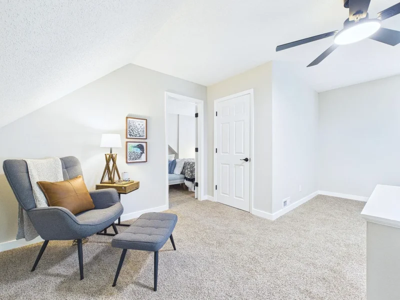 Upstairs landing with a seating area and ceiling fan