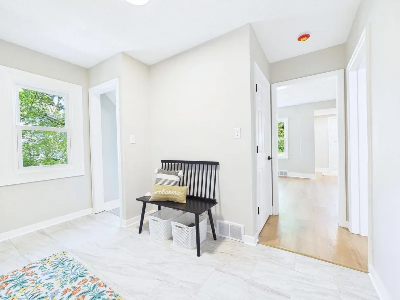 Entry with a bench and a view through to the next room