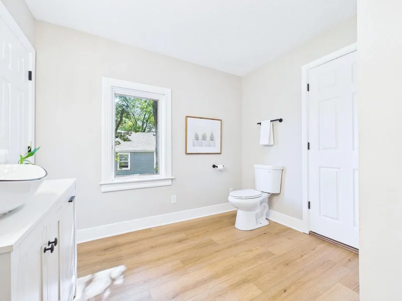 Bathroom with a vanity, toilet and window