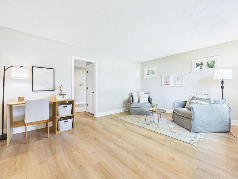 Open room set up with a desk and seating
