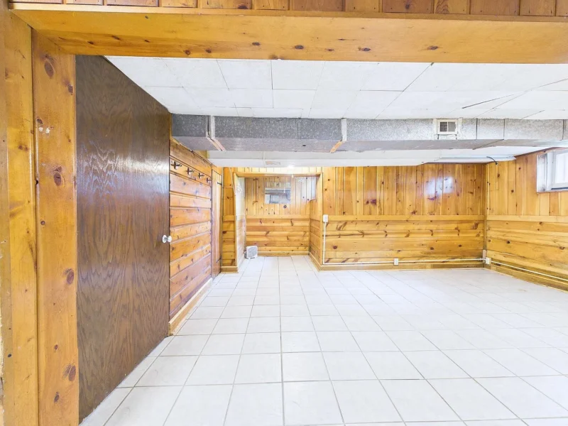 Lower level with wood panelling over a tiled floor